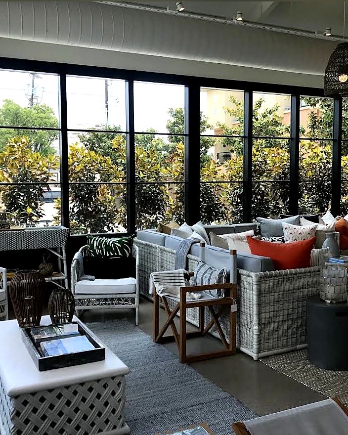 Large sunroom glass panels overlooking a furnished patio